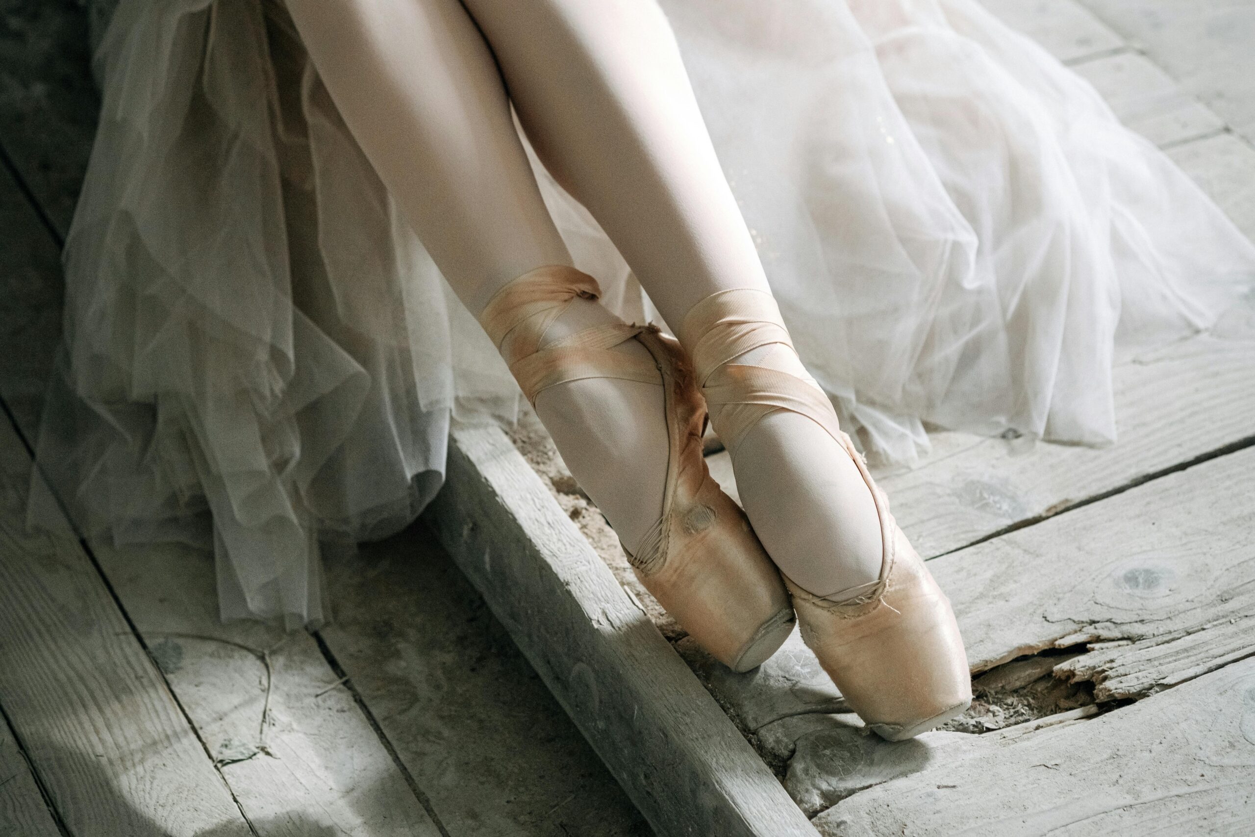 Graceful ballerina in pointe shoes captured in a serene and delicate setting, highlighting elegance.